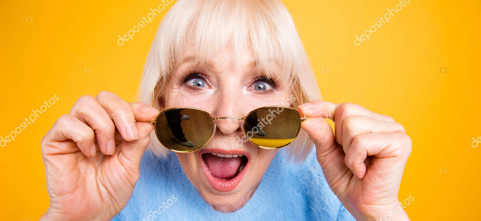 Total sale Old lady looks over the glasses with shocked look an